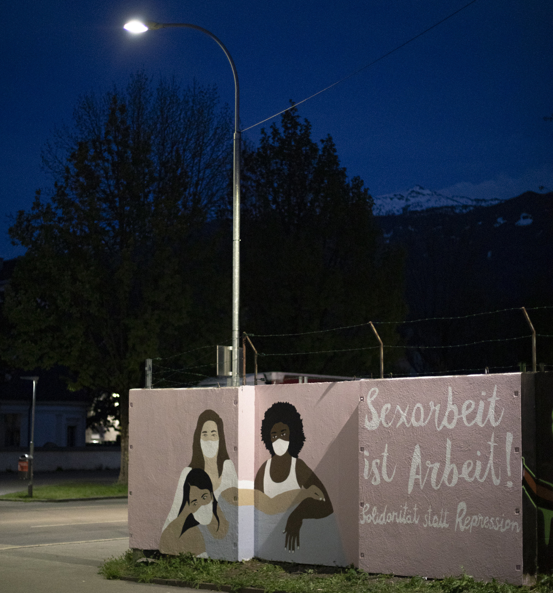 Photo von einem Wandbild mit drei Sexarbeiterinnen auf dem steht: Sexarbeit ist Arbeit, Solidarität statt Repression